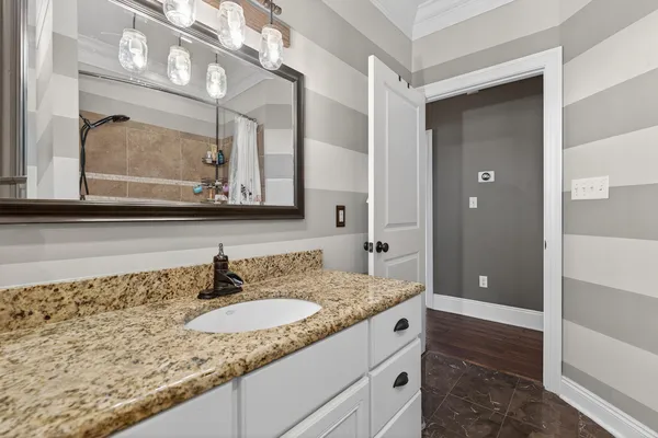 a kitchen with granite countertop a sink stainless steel appliances and window
