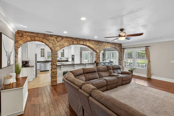 a spacious bedroom with a bed and a flat screen tv