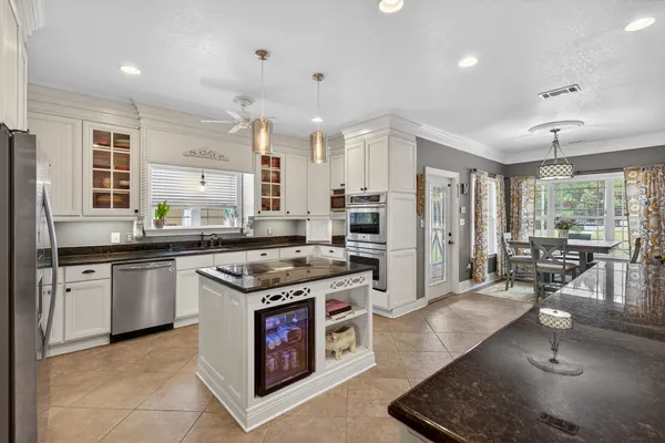 a bathroom with a granite countertop sink a mirror and shower