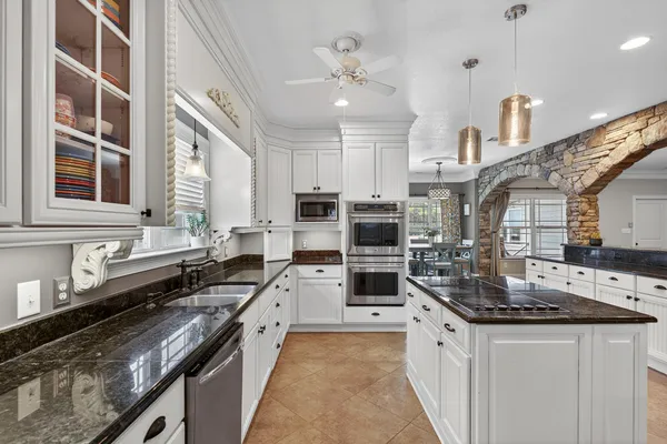 a view of an empty room with window and bathroom