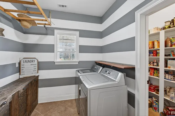 a view of a room with wooden floor and iron stairs