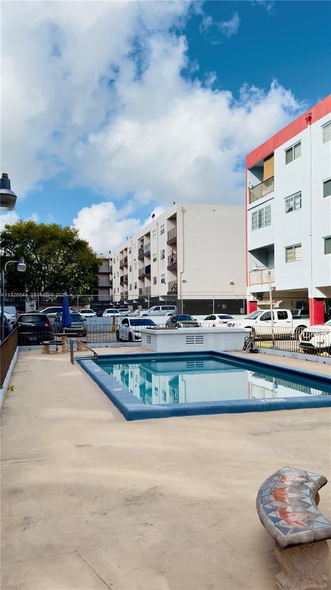 6070 West 19th Avenue, Unit 307 Hialeah, FL 33012 - Photo 15 of 19 a view of a swimming pool with outdoor seating