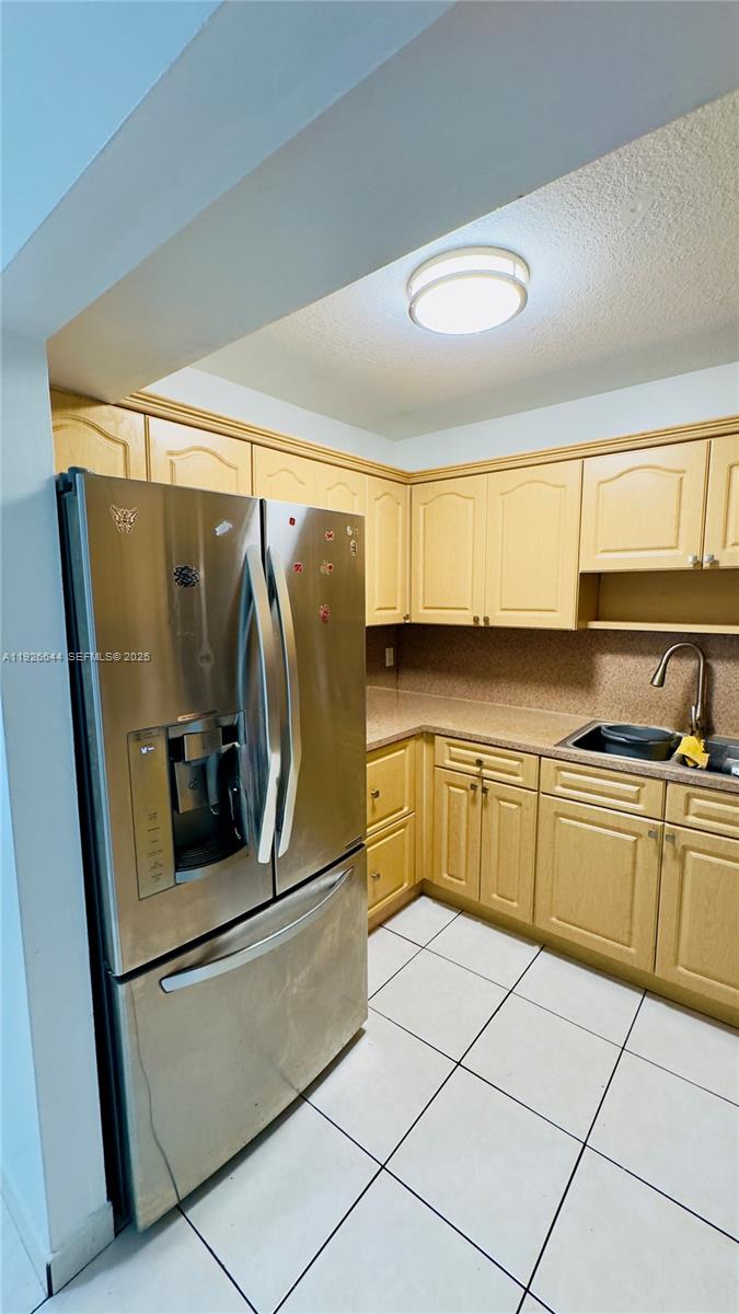 6070 West 19th Avenue, Unit 307 Hialeah, FL 33012 - Photo 4 of 19 a kitchen with stainless steel appliances granite countertop a refrigerator and a sink