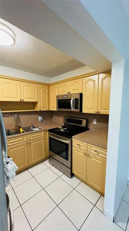 a kitchen with cabinets and appliances