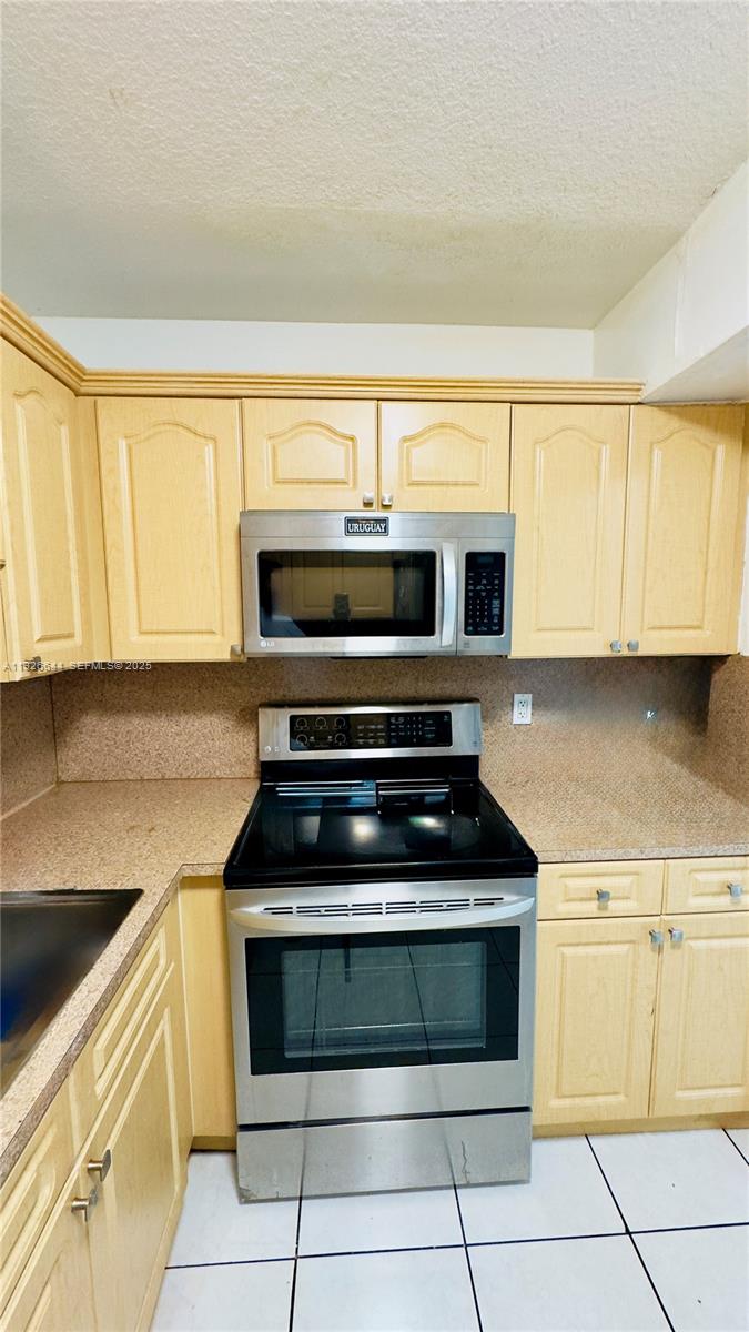 6070 West 19th Avenue, Unit 307 Hialeah, FL 33012 - Photo 6 of 19 a kitchen with cabinets and appliances