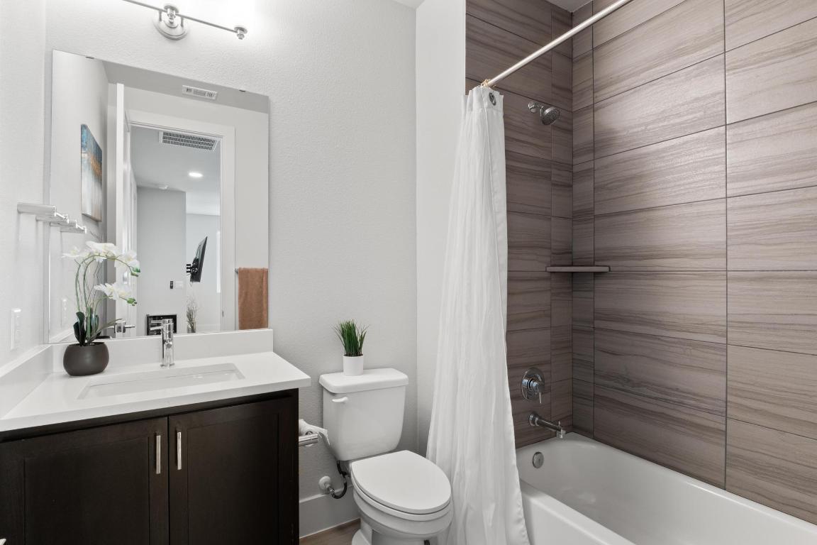 7924 Yellow Thistle Trail, Unit 39 Austin, TX 78735 - Photo 15 of 26 a bathroom with a sink a toilet and shower