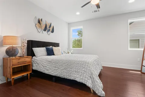 a bedroom with a bed and wooden floor