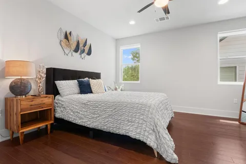 a bedroom with a bed and wooden floor