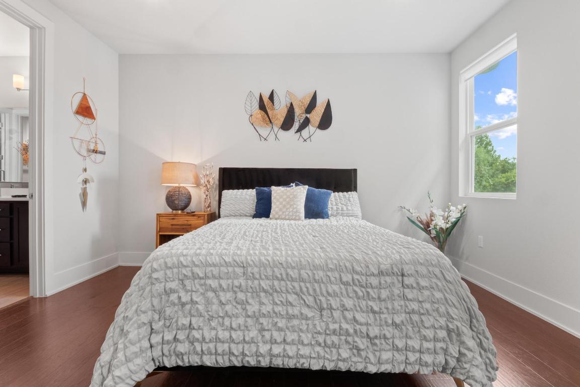 7924 Yellow Thistle Trail, Unit 39 Austin, TX 78735 - Photo 19 of 26 a bedroom with a bed and a painting on the wall