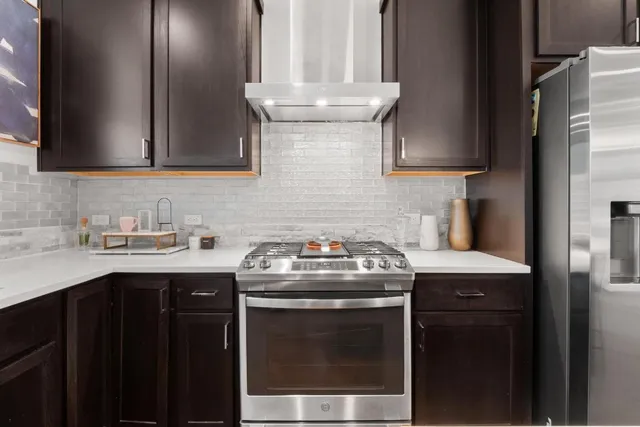 a kitchen with granite countertop a sink stainless steel appliances and cabinets