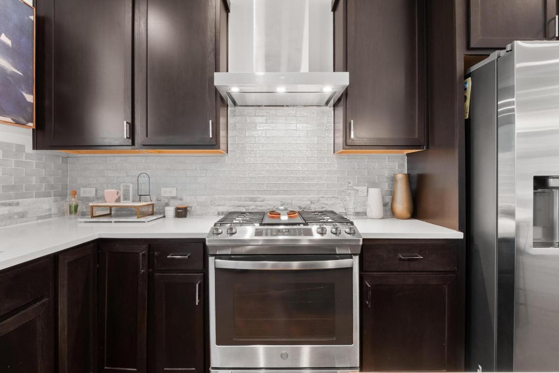 7924 Yellow Thistle Trail, Unit 39 Austin, TX 78735 - Photo 9 of 26 a kitchen with granite countertop a sink stainless steel appliances and cabinets