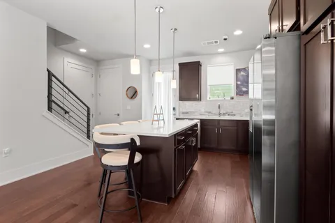 a kitchen with a table chairs sink and cabinets