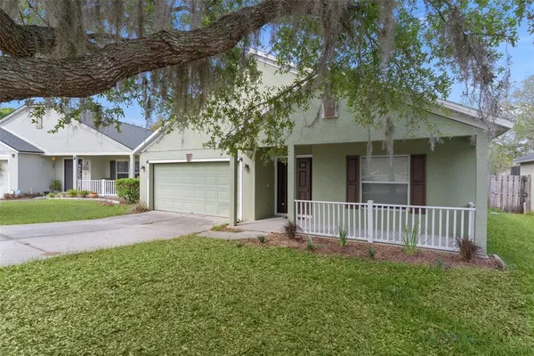 a front view of a house with a garden and yard