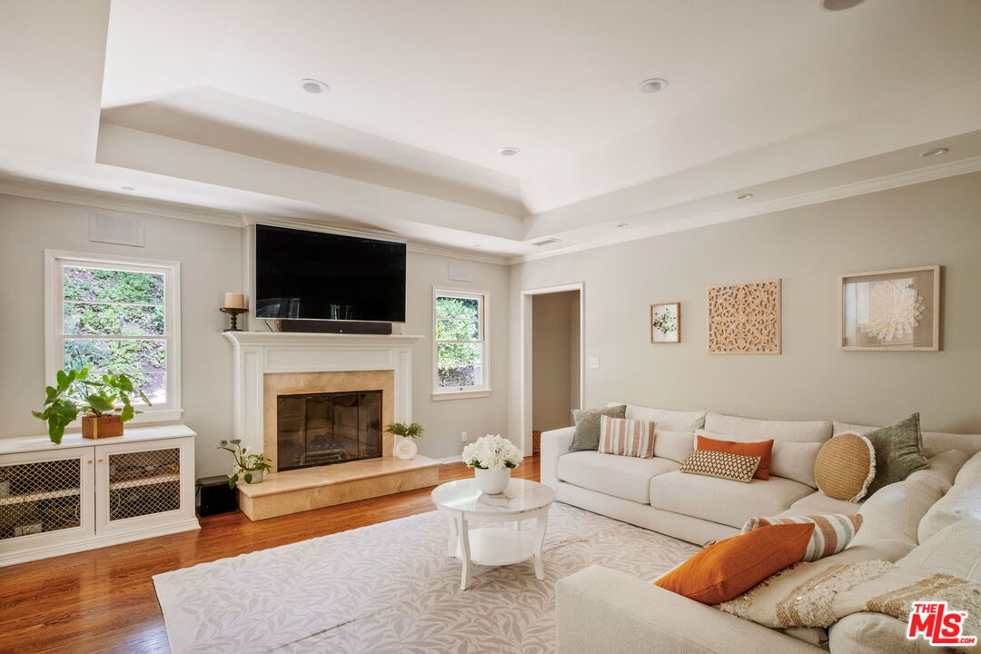 1265 Inverness Drive Pasadena, CA 91103 - Photo 11 of 56 a living room with furniture a flat screen tv and a fireplace