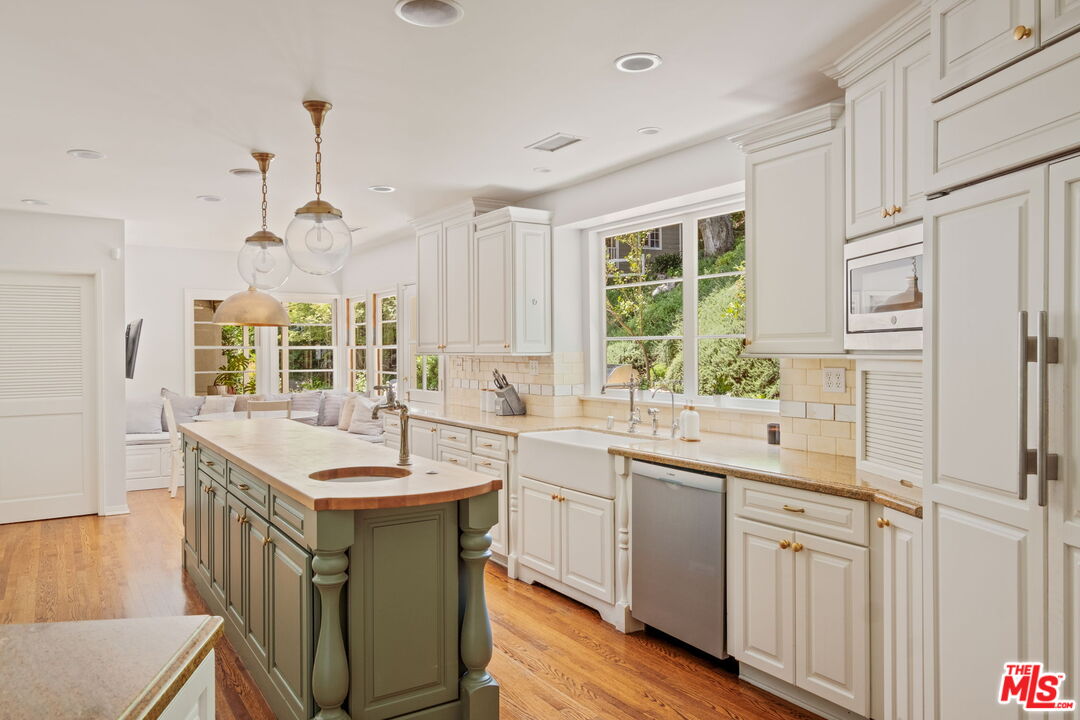 1265 Inverness Drive Pasadena, CA 91103 - Photo 20 of 56 a kitchen with a sink stove and cabinets
