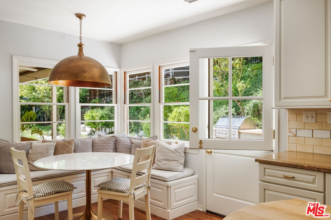 1265 Inverness Drive Pasadena, CA 91103 - Photo 23 of 56 a dining room with a large window and table