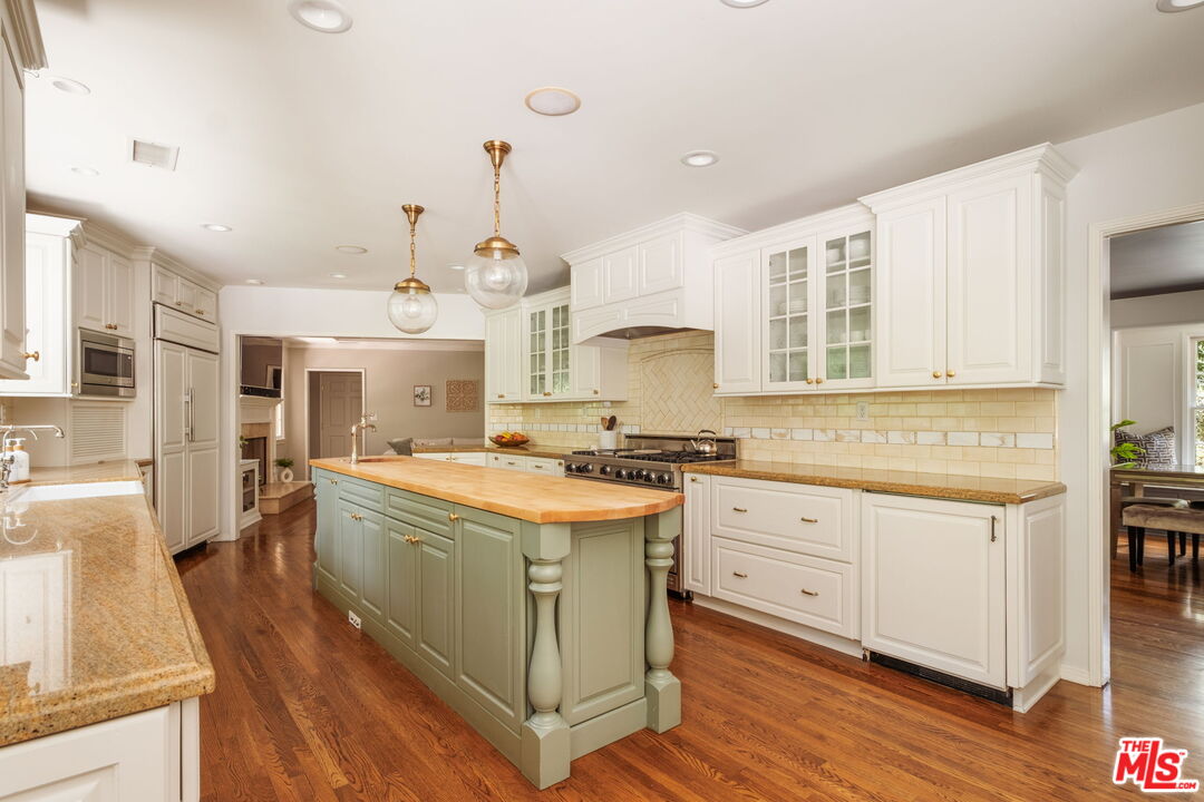 1265 Inverness Drive Pasadena, CA 91103 - Photo 25 of 56 a kitchen with a stove a sink and wooden floor
