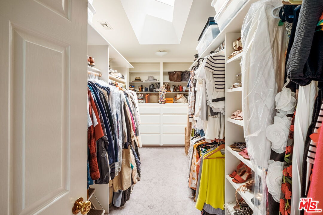 1265 Inverness Drive Pasadena, CA 91103 - Photo 32 of 56 a view of walk in closet with clothes and shoes
