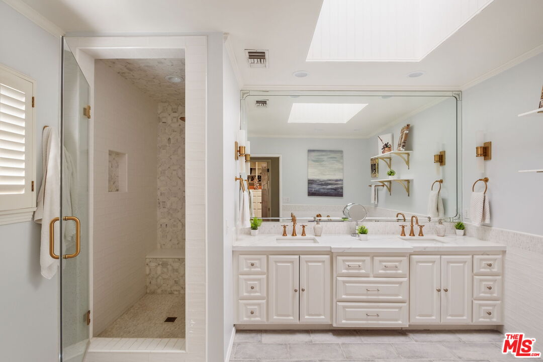 1265 Inverness Drive Pasadena, CA 91103 - Photo 33 of 56 a bathroom with a double vanity sink mirror double shower and a mirror