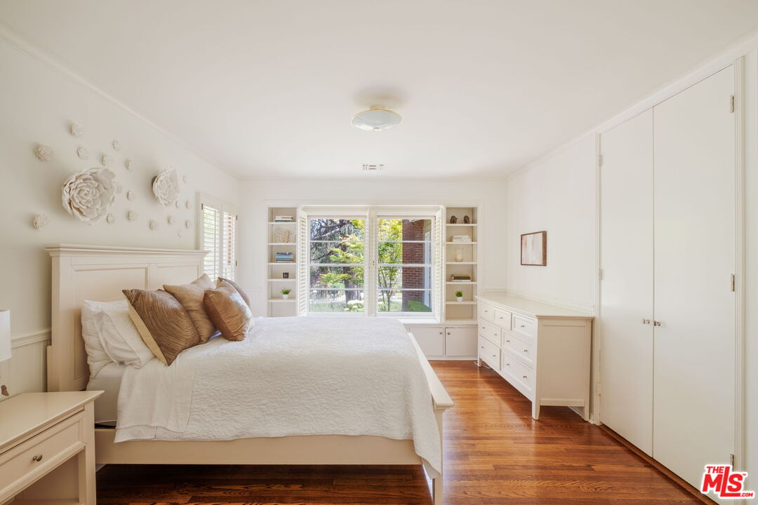1265 Inverness Drive Pasadena, CA 91103 - Photo 36 of 56 a spacious bedroom with a bed and wooden floor