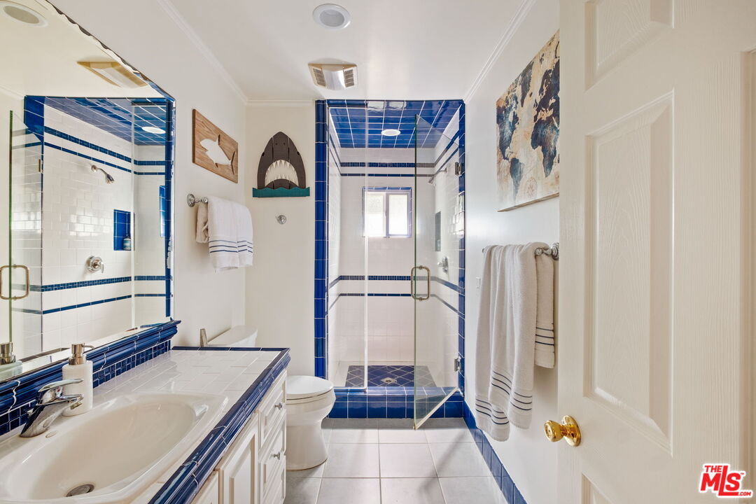 1265 Inverness Drive Pasadena, CA 91103 - Photo 39 of 56 a bathroom with a sink a toilet and shower