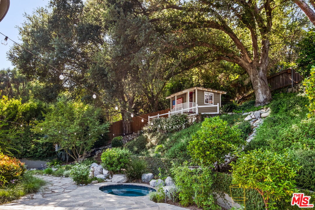1265 Inverness Drive Pasadena, CA 91103 - Photo 47 of 56 a front view of a house with a yard and potted plants