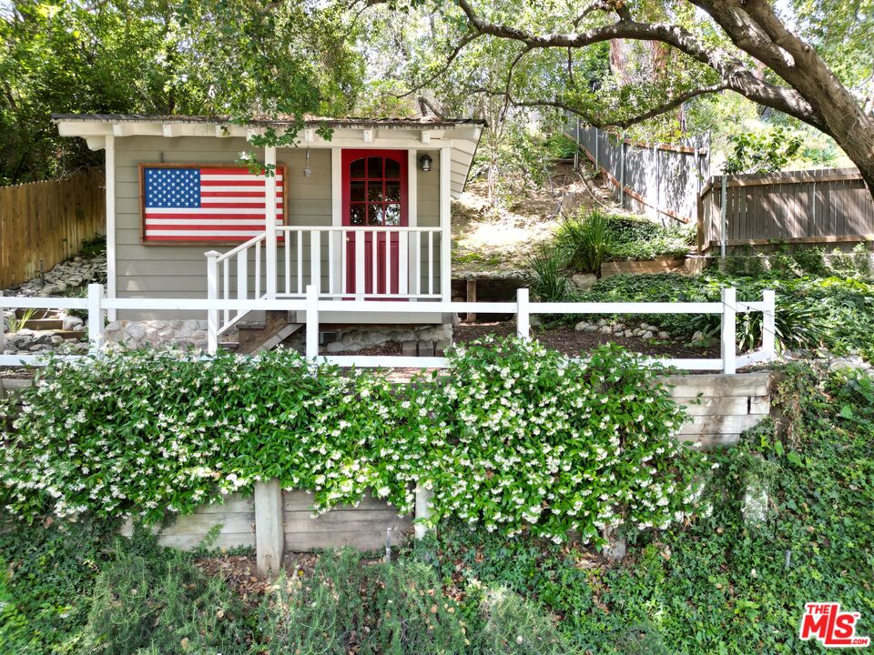 1265 Inverness Drive Pasadena, CA 91103 - Photo 48 of 56 a backyard of a house with lots of green space and fountain