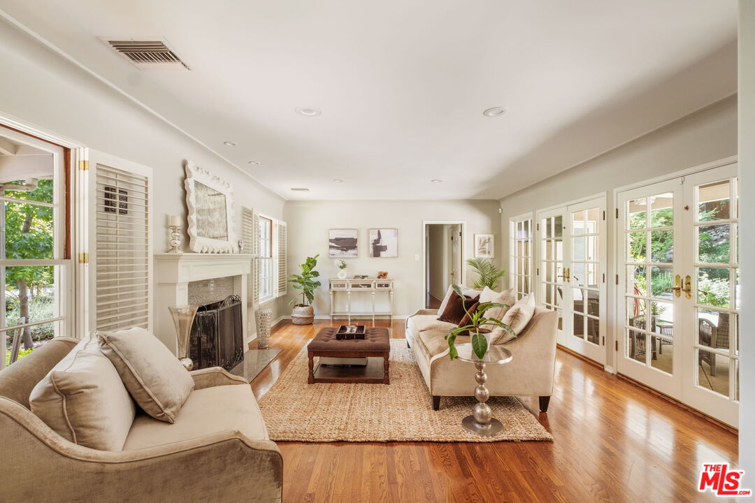 1265 Inverness Drive Pasadena, CA 91103 - Photo 5 of 56 a living room with furniture fireplace and a large window
