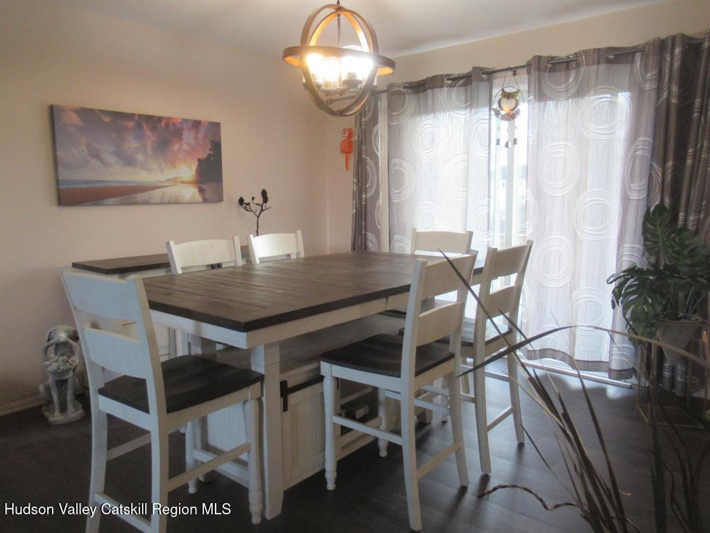 22 River Glen Road Wallkill, NY 12589 - Photo 4 of 8 a view of a dining room with furniture window and chandelier