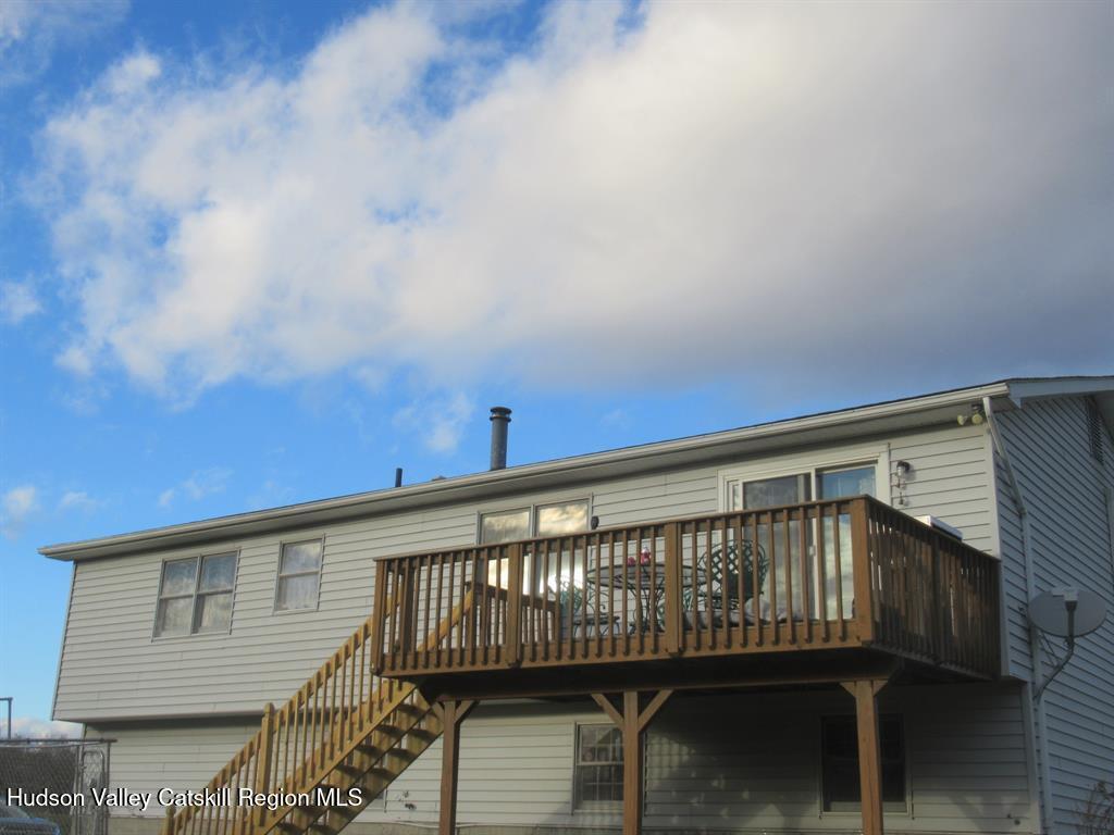 22 River Glen Road Wallkill, NY 12589 - Photo 8 of 8 a view of a roof deck with wooden floor and fence