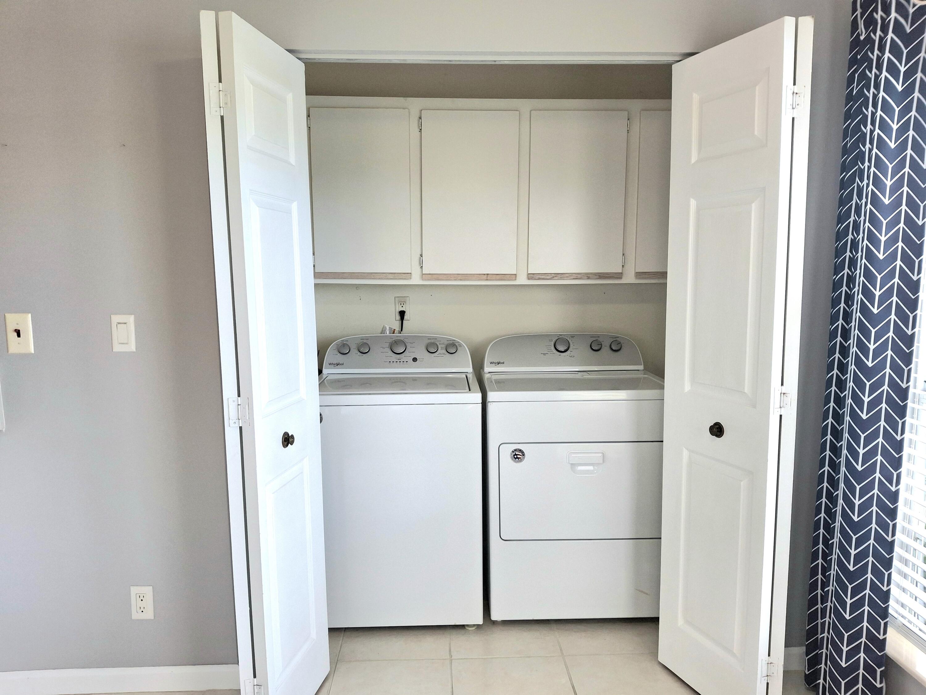 8483 Schefflera Court Port St. Lucie, FL 34952 - Photo 12 of 33 a utility room with dryer and washer
