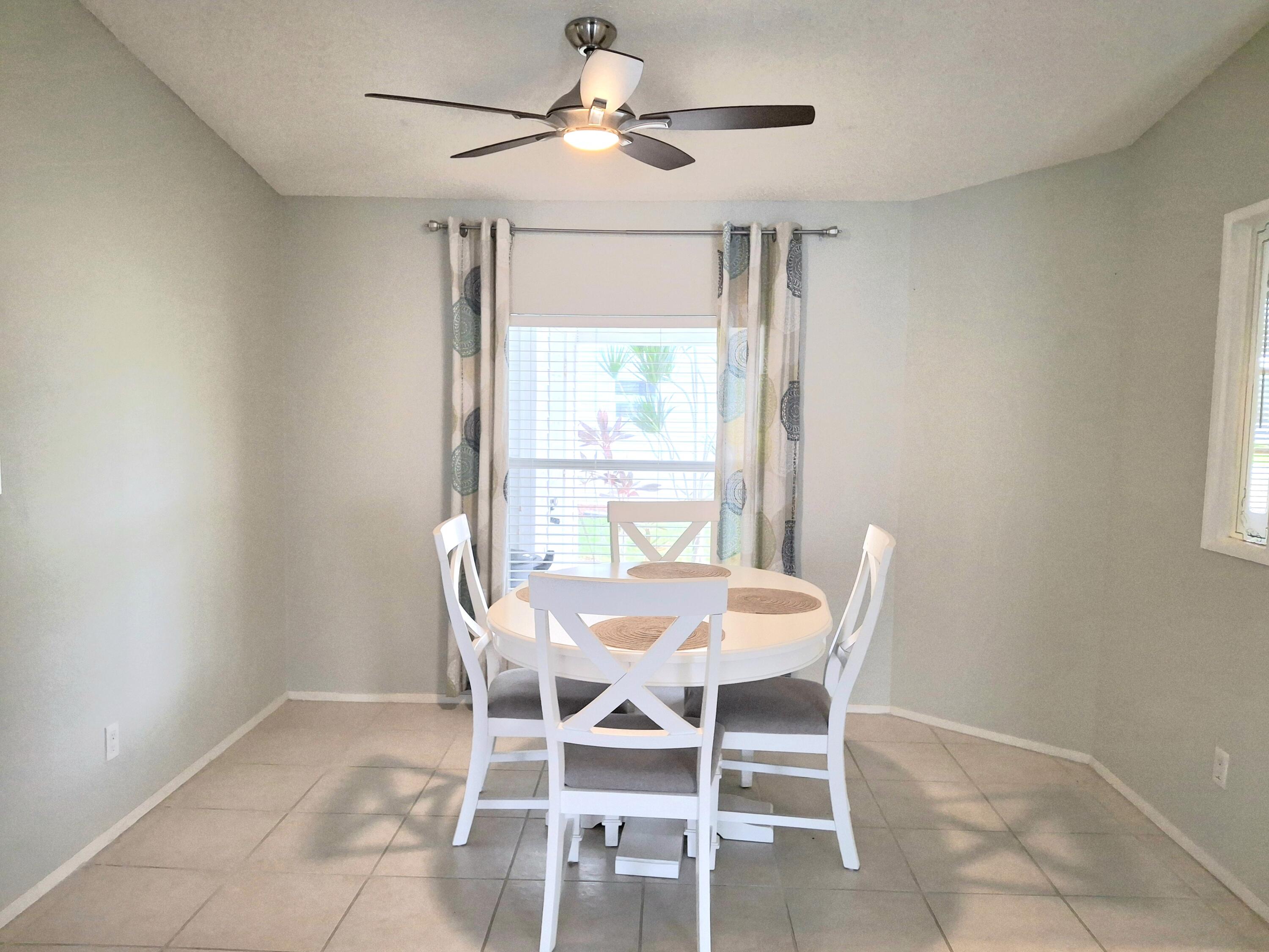 8483 Schefflera Court Port St. Lucie, FL 34952 - Photo 13 of 33 a dining room with furniture and window