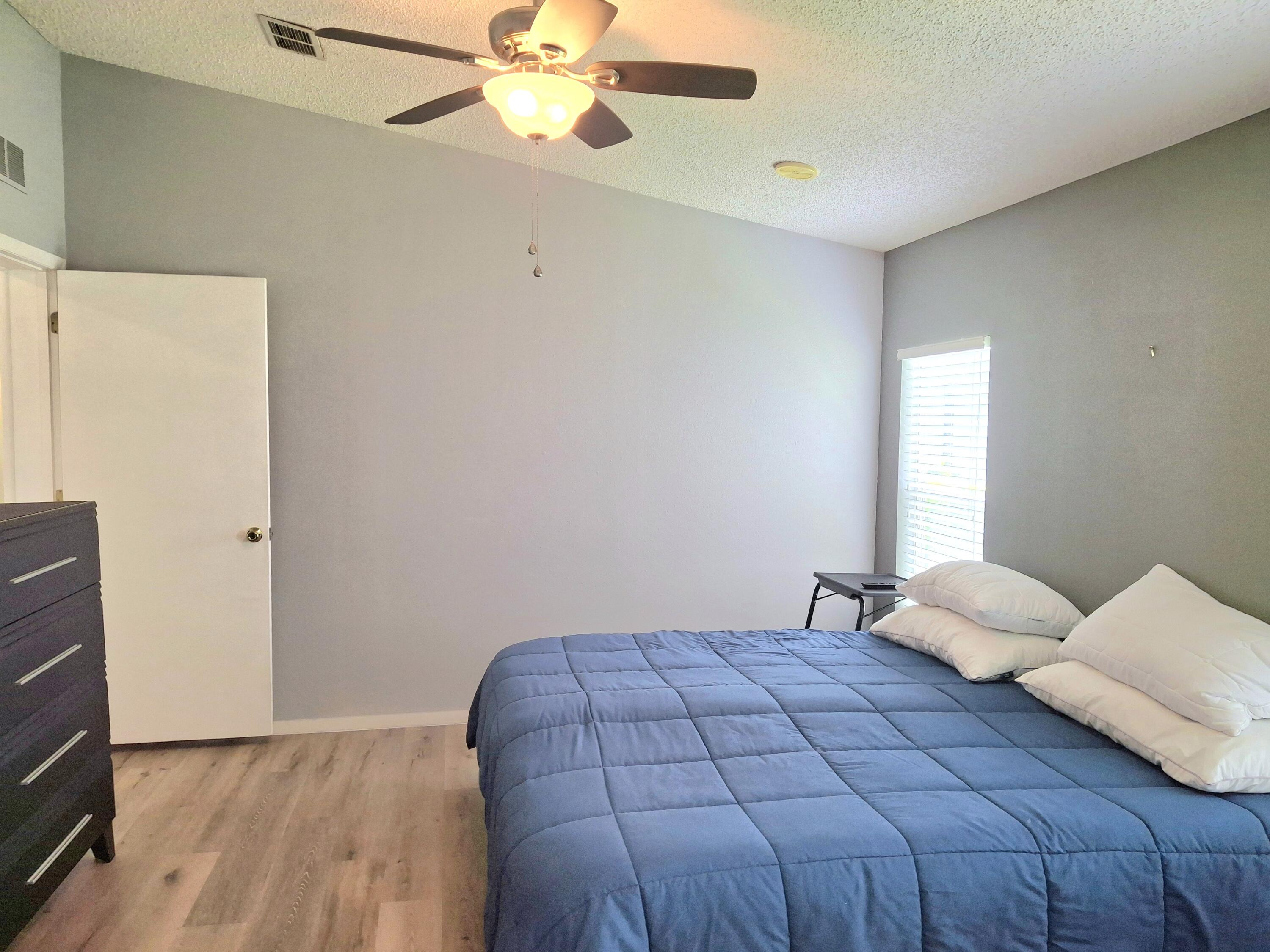 8483 Schefflera Court Port St. Lucie, FL 34952 - Photo 16 of 33 a bedroom with a bed and window