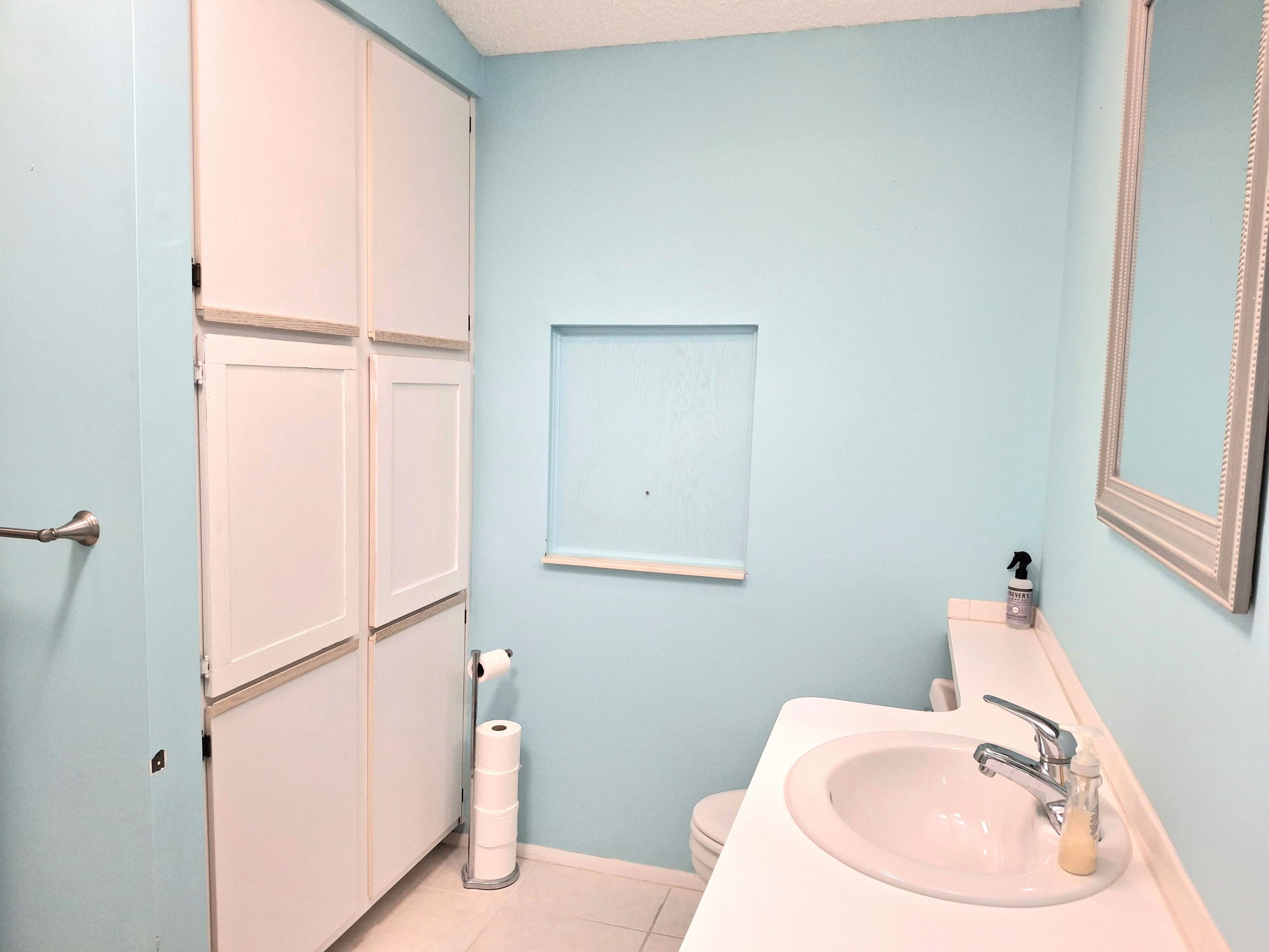 8483 Schefflera Court Port St. Lucie, FL 34952 - Photo 18 of 33 a bathroom with a sink and a mirror