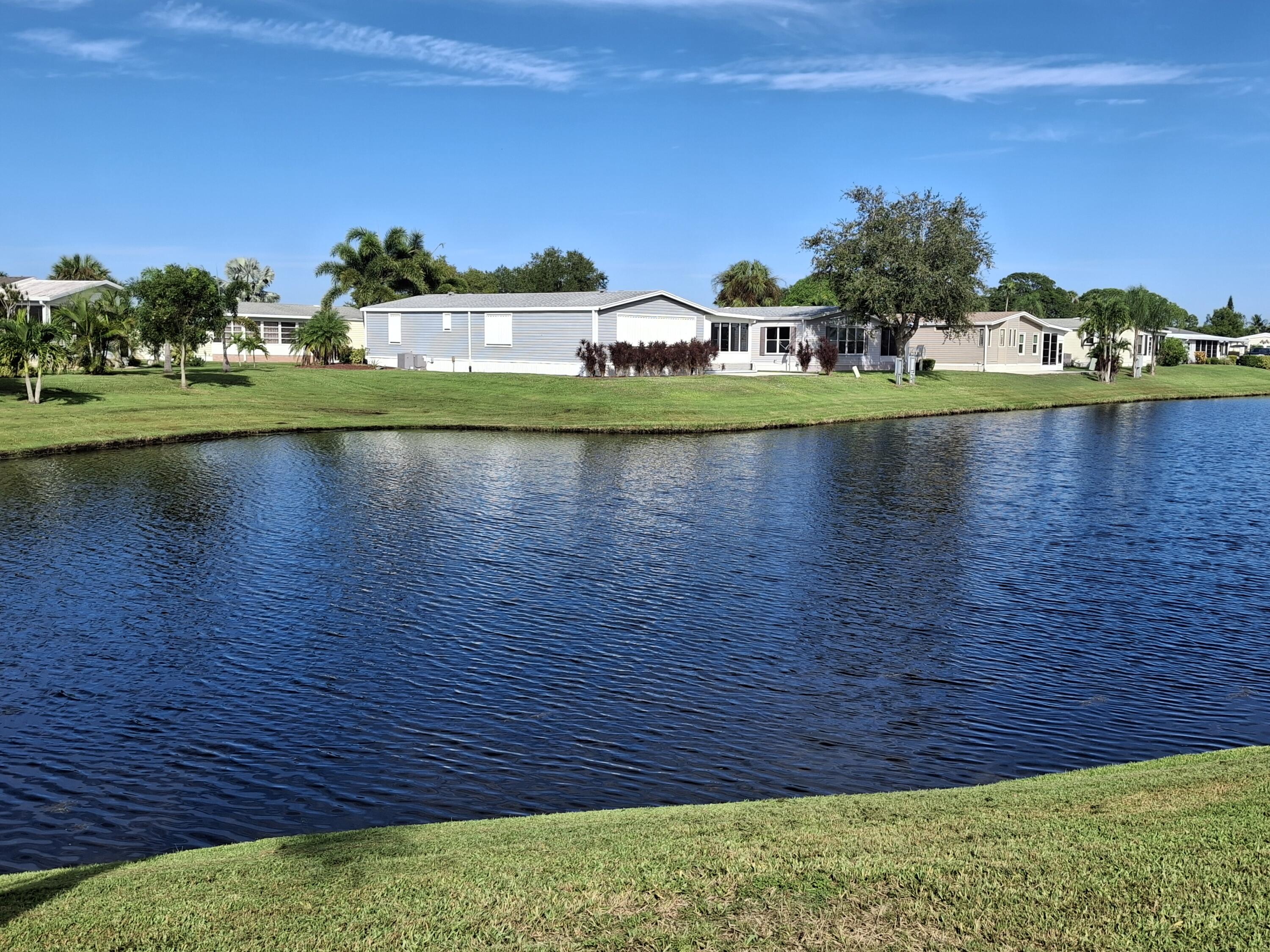8483 Schefflera Court Port St. Lucie, FL 34952 - Photo 2 of 33 a view of swimming pool with outdoor space and seating