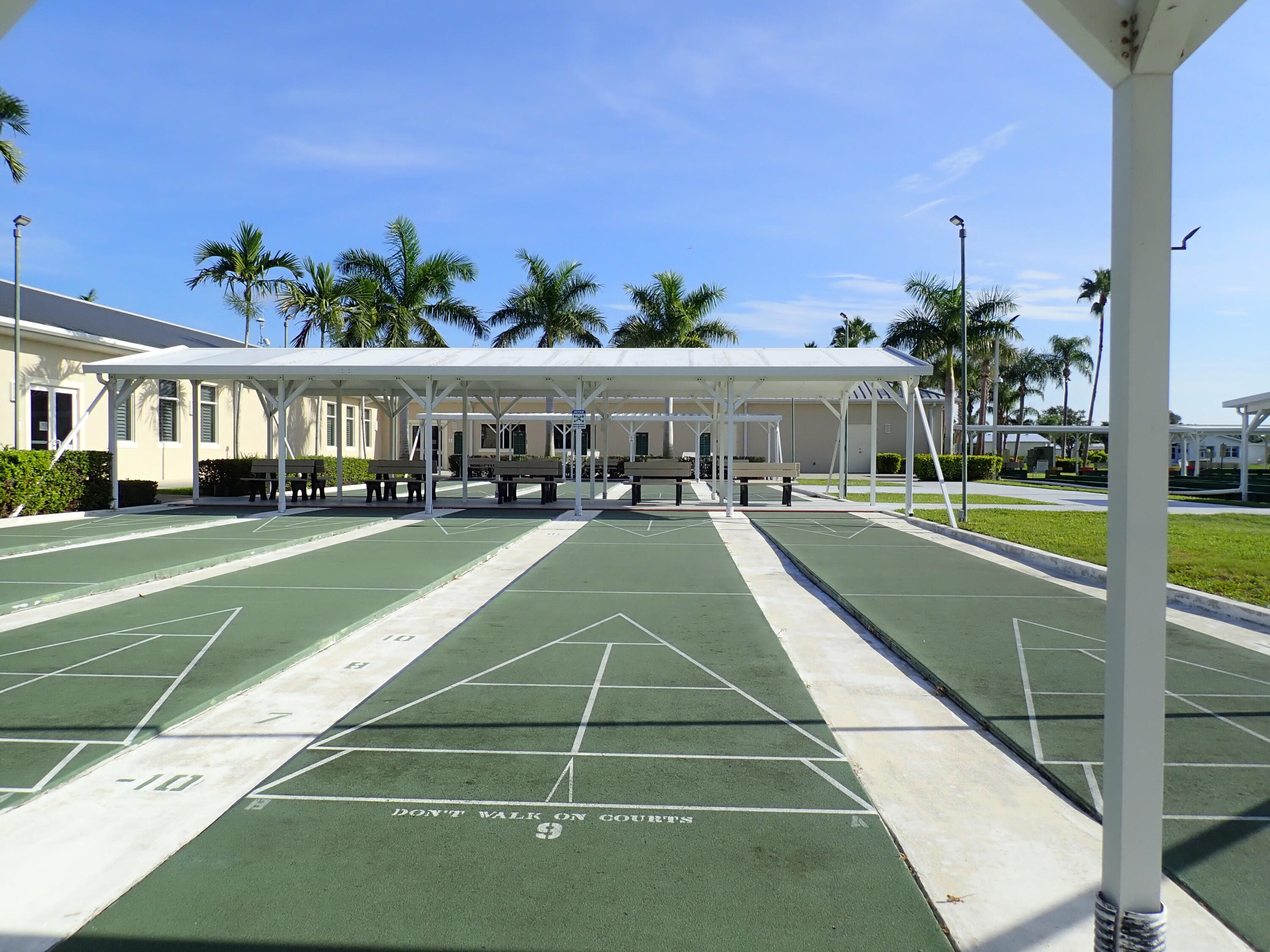 8483 Schefflera Court Port St. Lucie, FL 34952 - Photo 32 of 33 a view of a tennis ground with a large pool