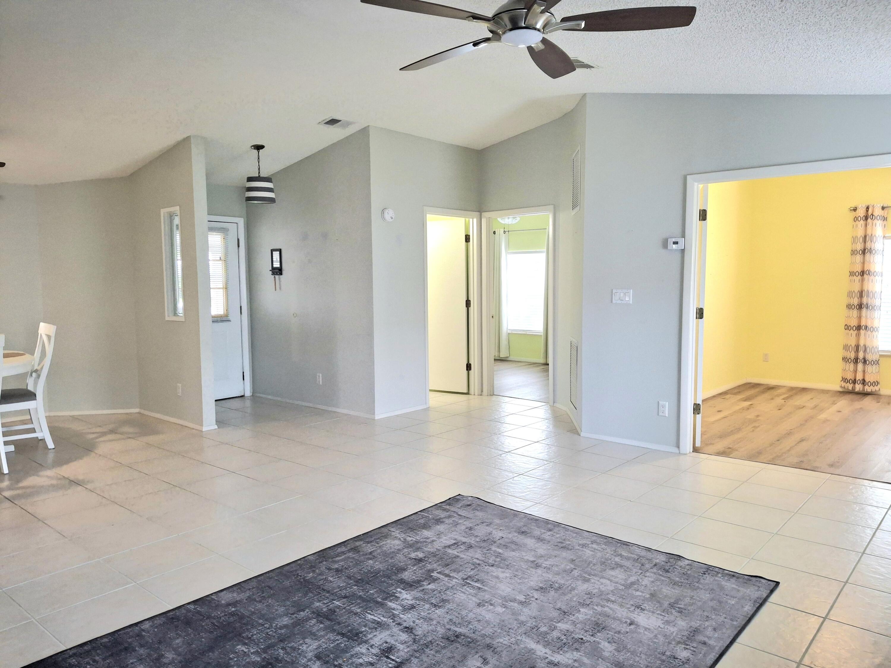 8483 Schefflera Court Port St. Lucie, FL 34952 - Photo 5 of 33 a view of a livingroom with a staircase