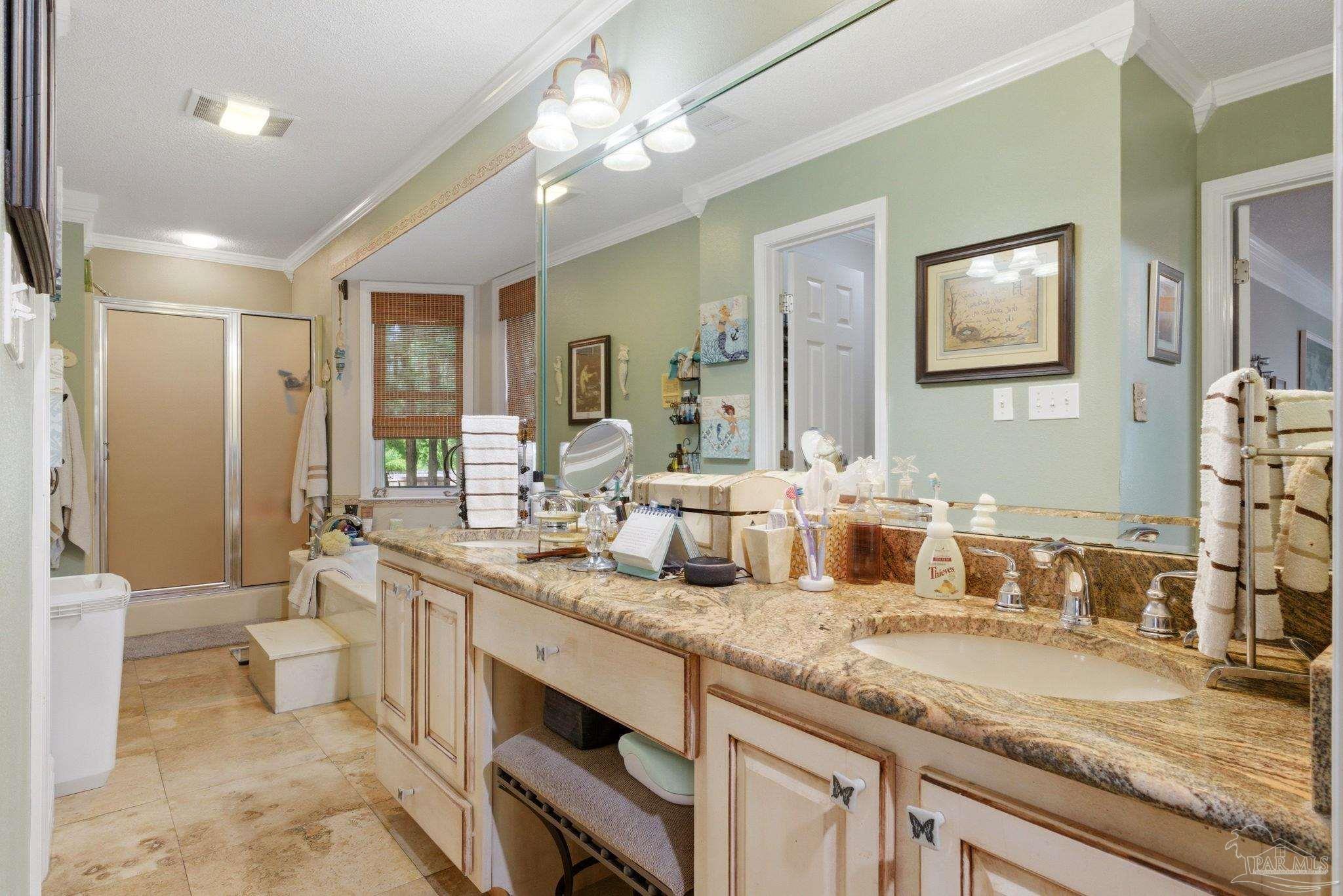 6930 Summit Way Milton, FL 32570 - Photo 29 of 71 a bathroom with a granite countertop sink a toilet a mirror and shower