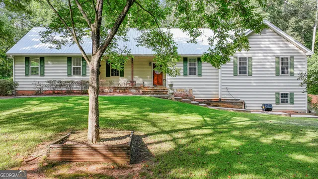 a front view of house with yard and green space