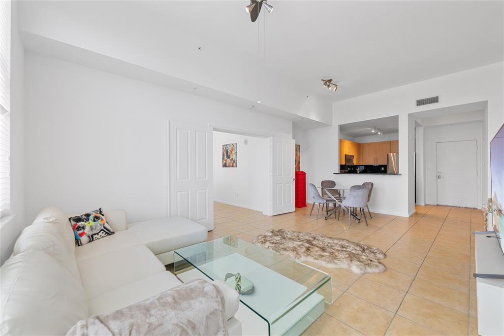 511 Southeast 5th Avenue, Unit 1906 Fort Lauderdale, FL 33301 - Photo 11 of 64 a living room with furniture and a flat screen tv
