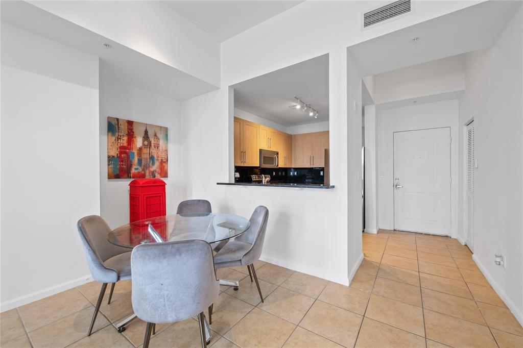 511 Southeast 5th Avenue, Unit 1906 Fort Lauderdale, FL 33301 - Photo 12 of 64 a view of a dining room with furniture and a potted plant