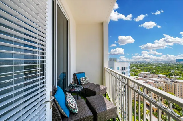 a view of a balcony with furniture and a potted plant