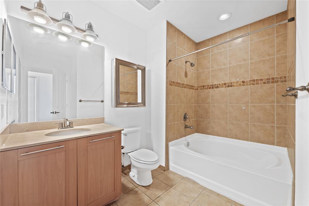 511 Southeast 5th Avenue, Unit 1906 Fort Lauderdale, FL 33301 - Photo 24 of 64 a bathroom with a granite countertop sink a toilet and bathtub