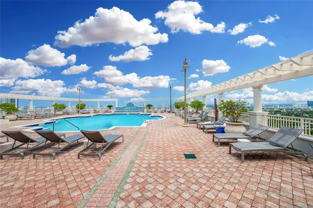 a living room with lots of furniture and kitchen view