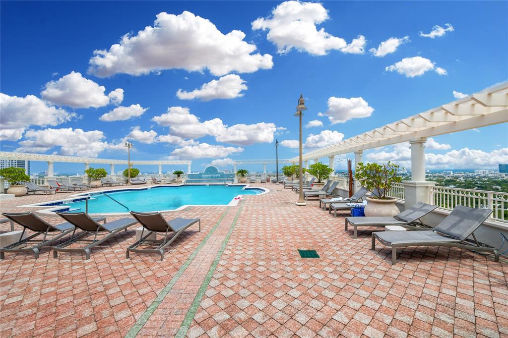 511 Southeast 5th Avenue, Unit 1906 Fort Lauderdale, FL 33301 - Photo 27 of 64 a view of a patio with a dining table and chairs