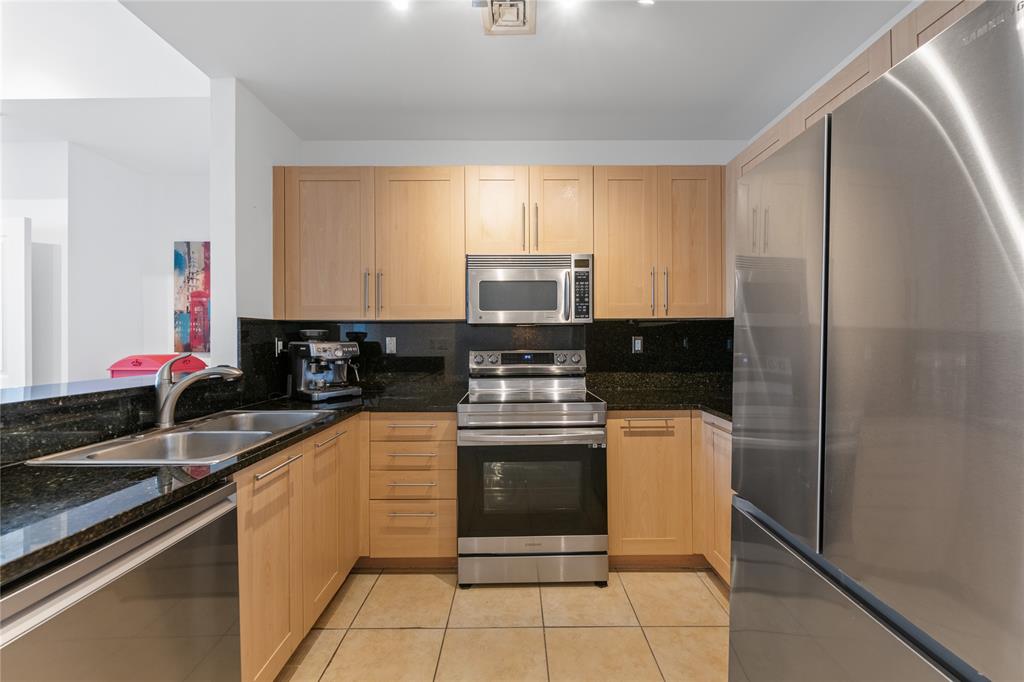 511 Southeast 5th Avenue, Unit 1906 Fort Lauderdale, FL 33301 - Photo 9 of 64 a kitchen with stainless steel appliances granite countertop a stove a sink and a refrigerator
