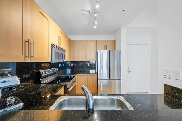 a view of a dining room with furniture and a potted plant