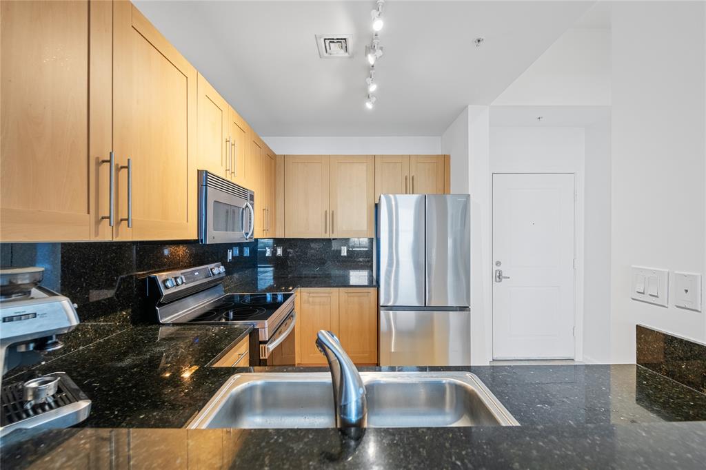 511 Southeast 5th Avenue, Unit 1906 Fort Lauderdale, FL 33301 - Photo 10 of 64 a kitchen with sink refrigerator and cabinets
