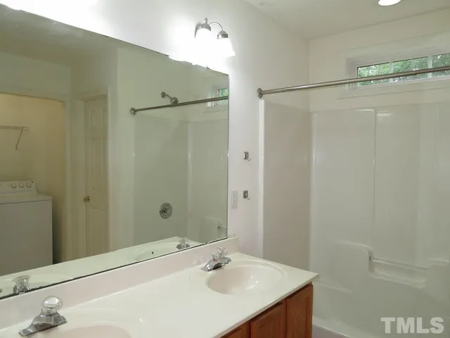 a bathroom with a sink and shower