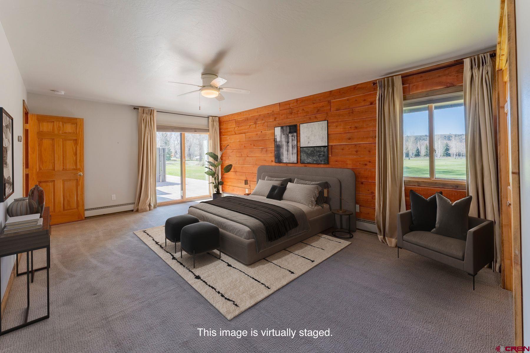 169 Camino Del Rio, Unit 8 Gunnison, CO 81230 - Photo 14 of 35 a bedroom with a bed couch and windows